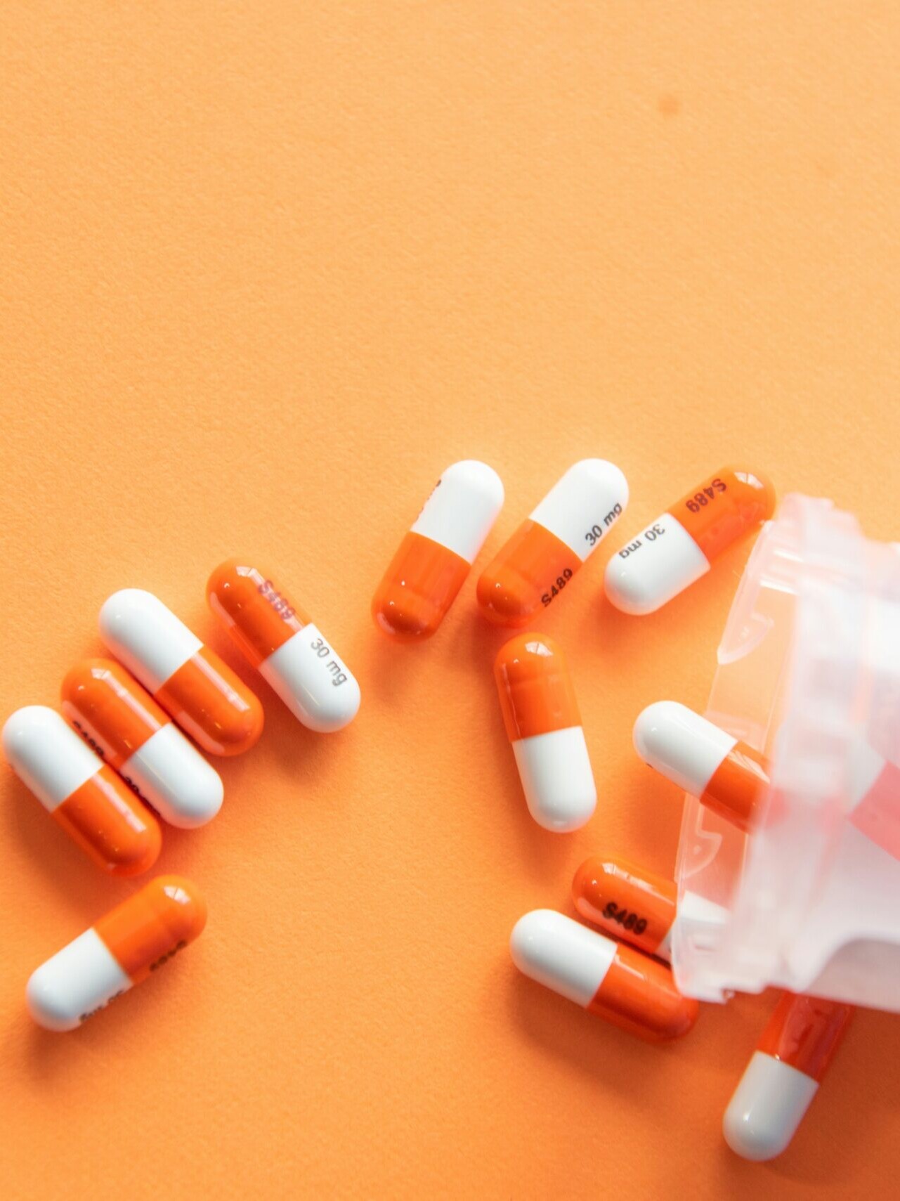 orange and white medication pill