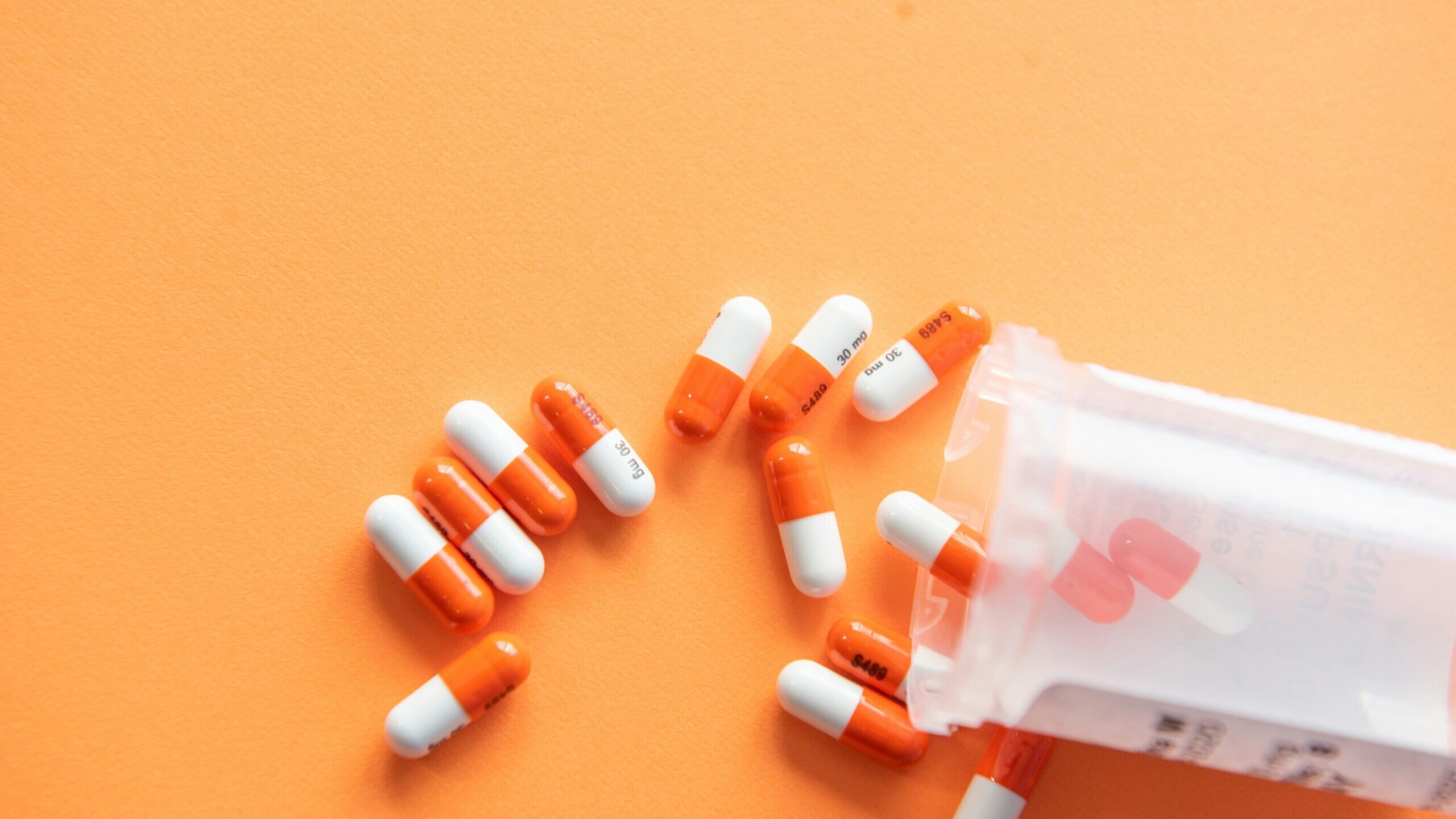 orange and white medication pill