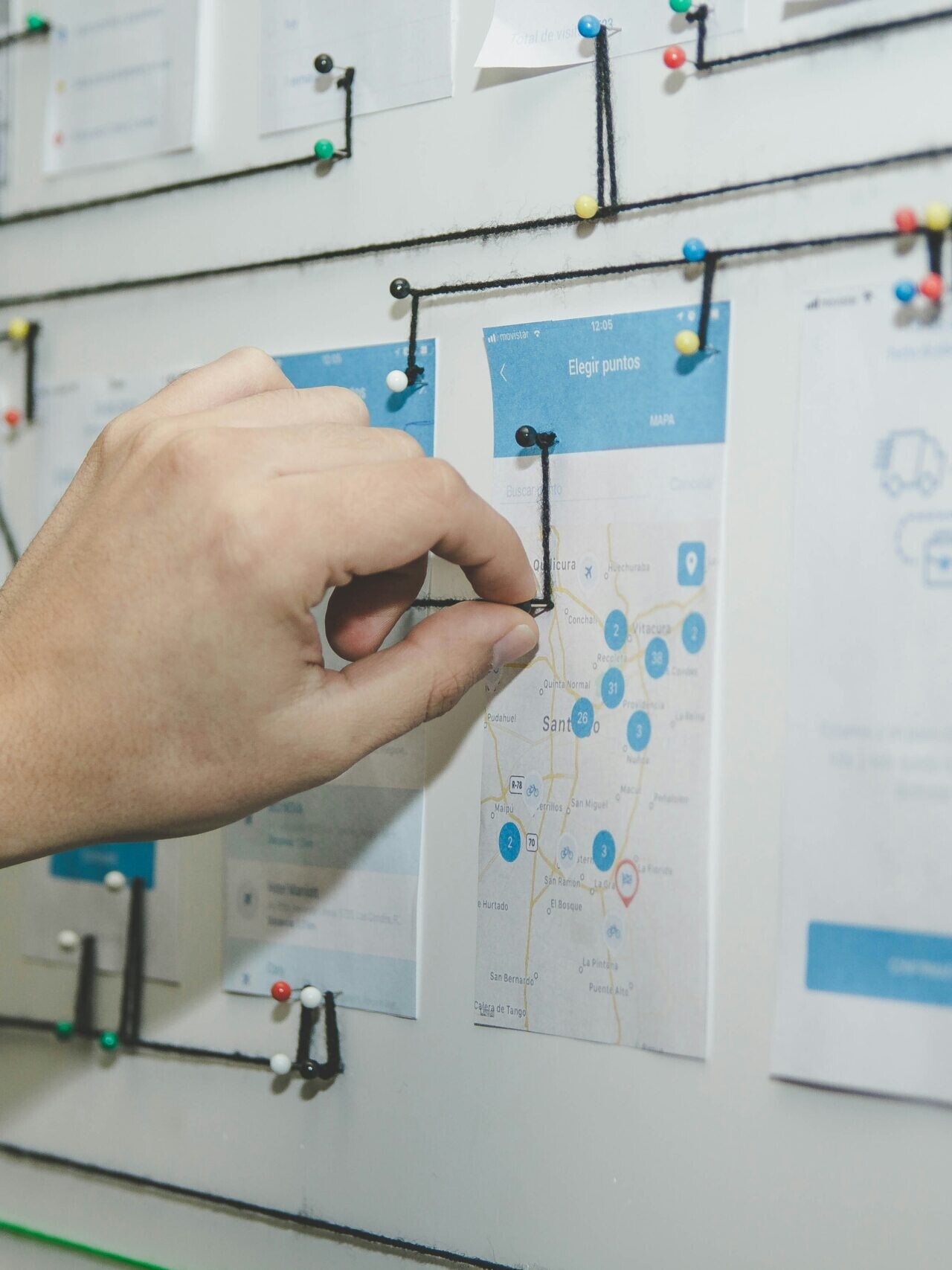 person working on blue and white paper on board