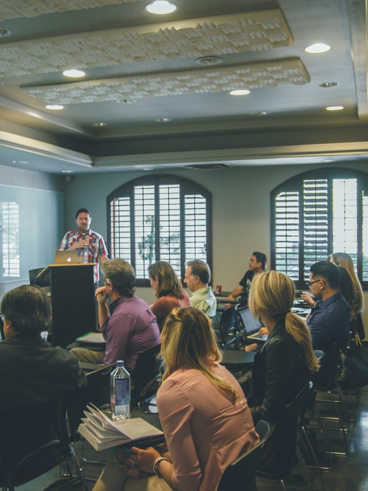 a group of people in a room with a projector screen