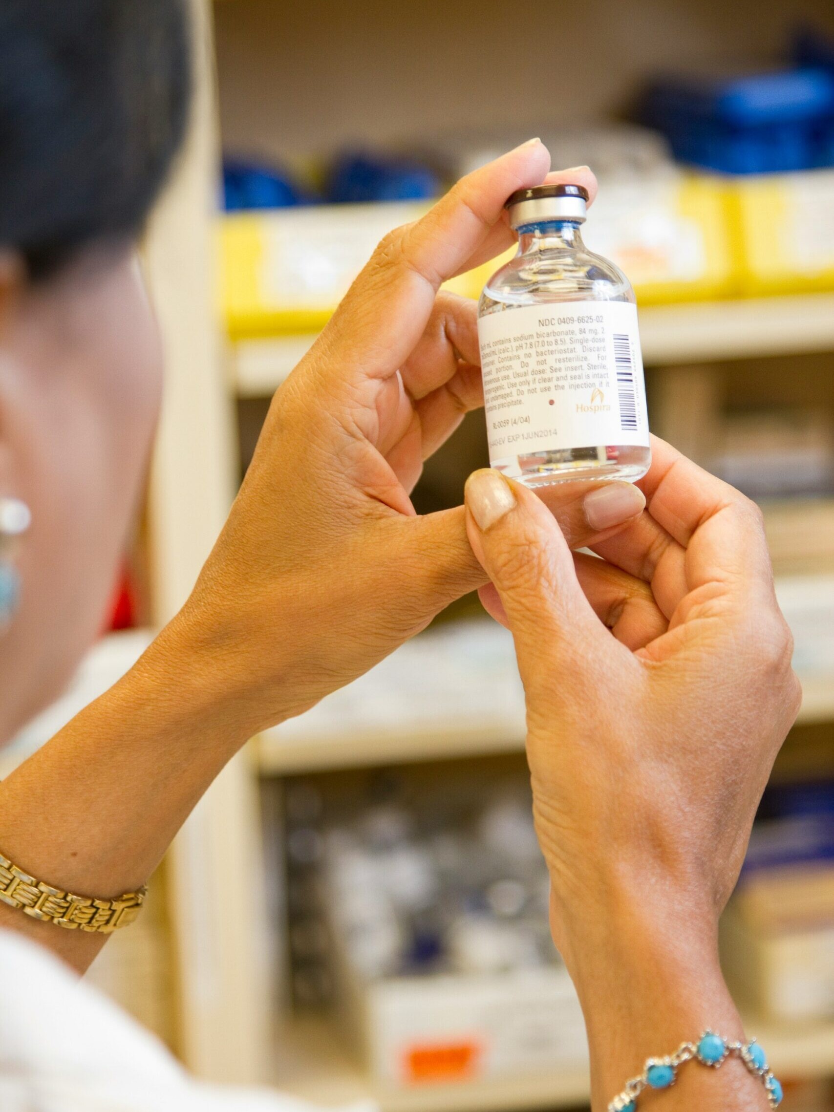 person holding white labeled bottle