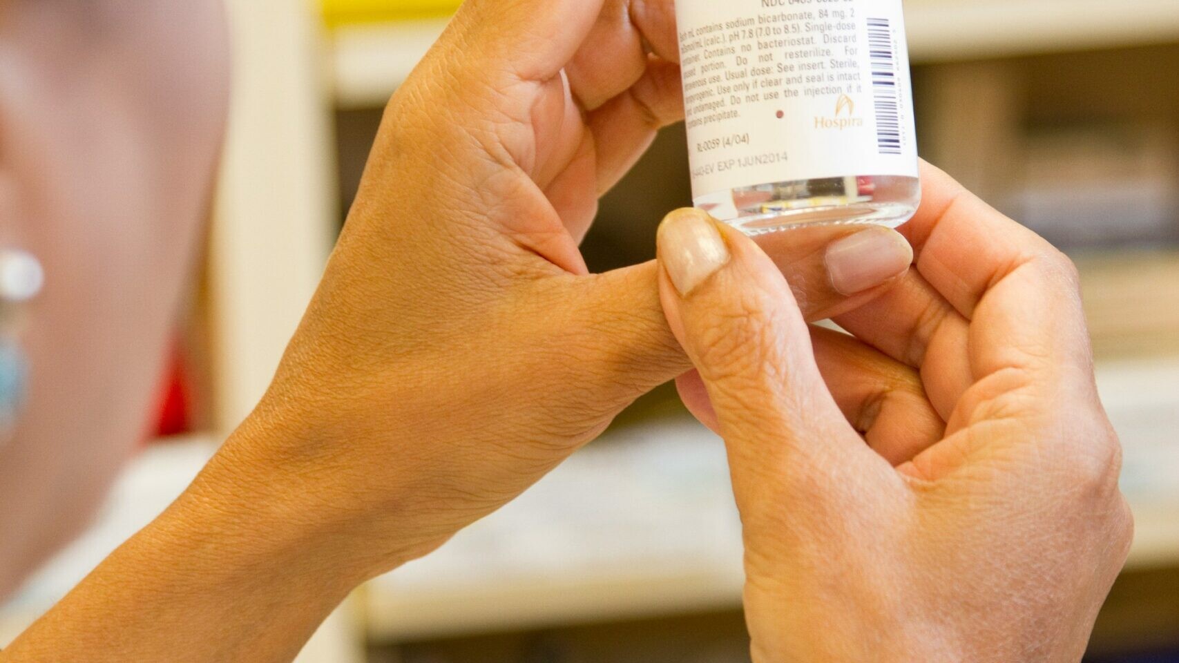 person holding white labeled bottle