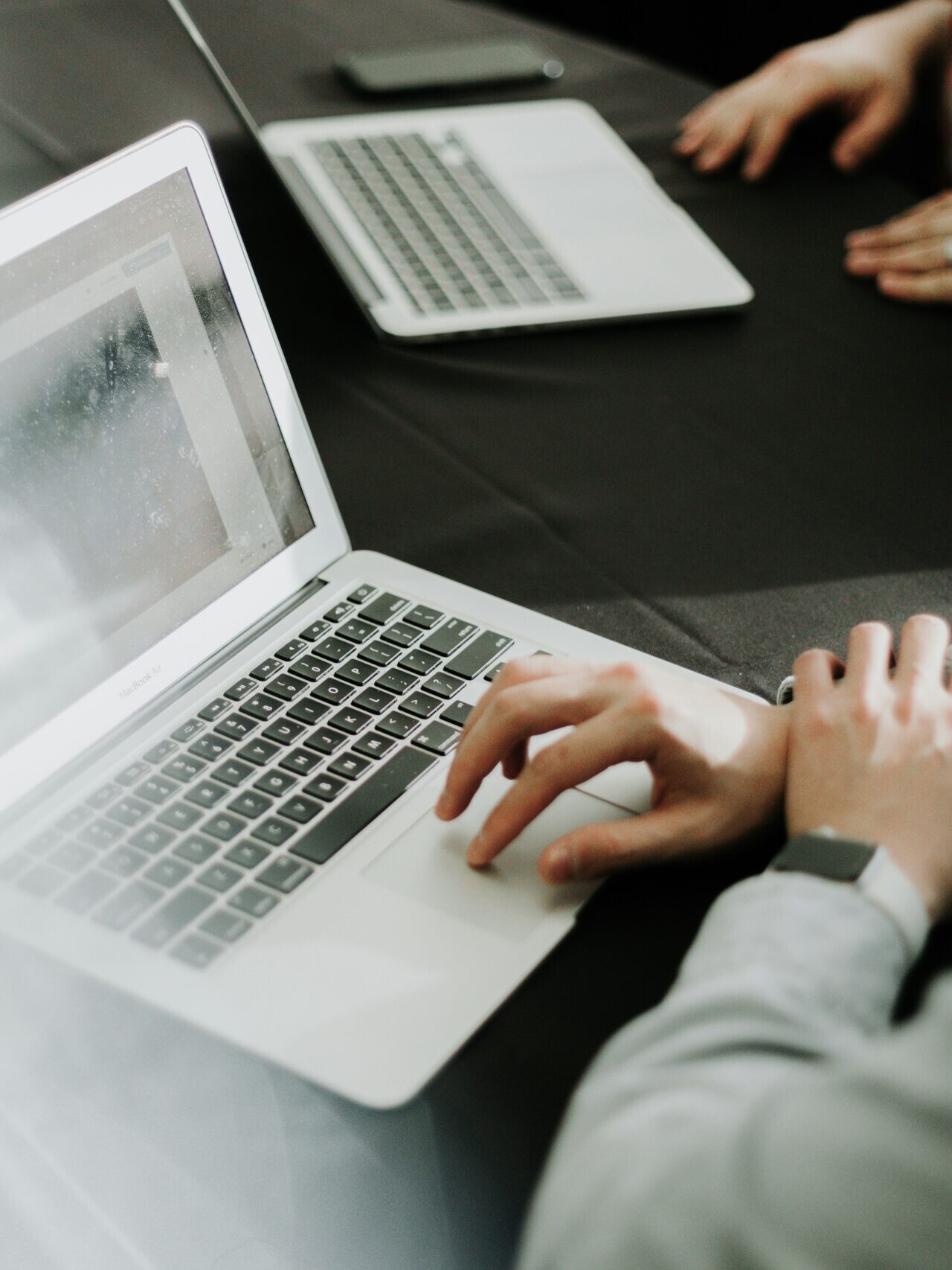 a man sitting in front of a laptop computer