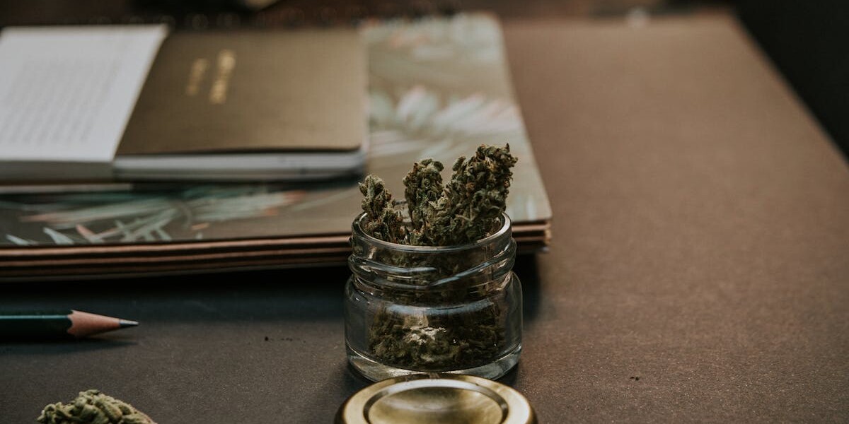 Close-Up Photo of Kush On Glass Container