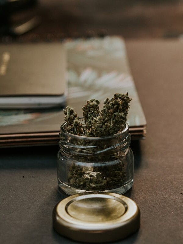 Close-Up Photo of Kush On Glass Container