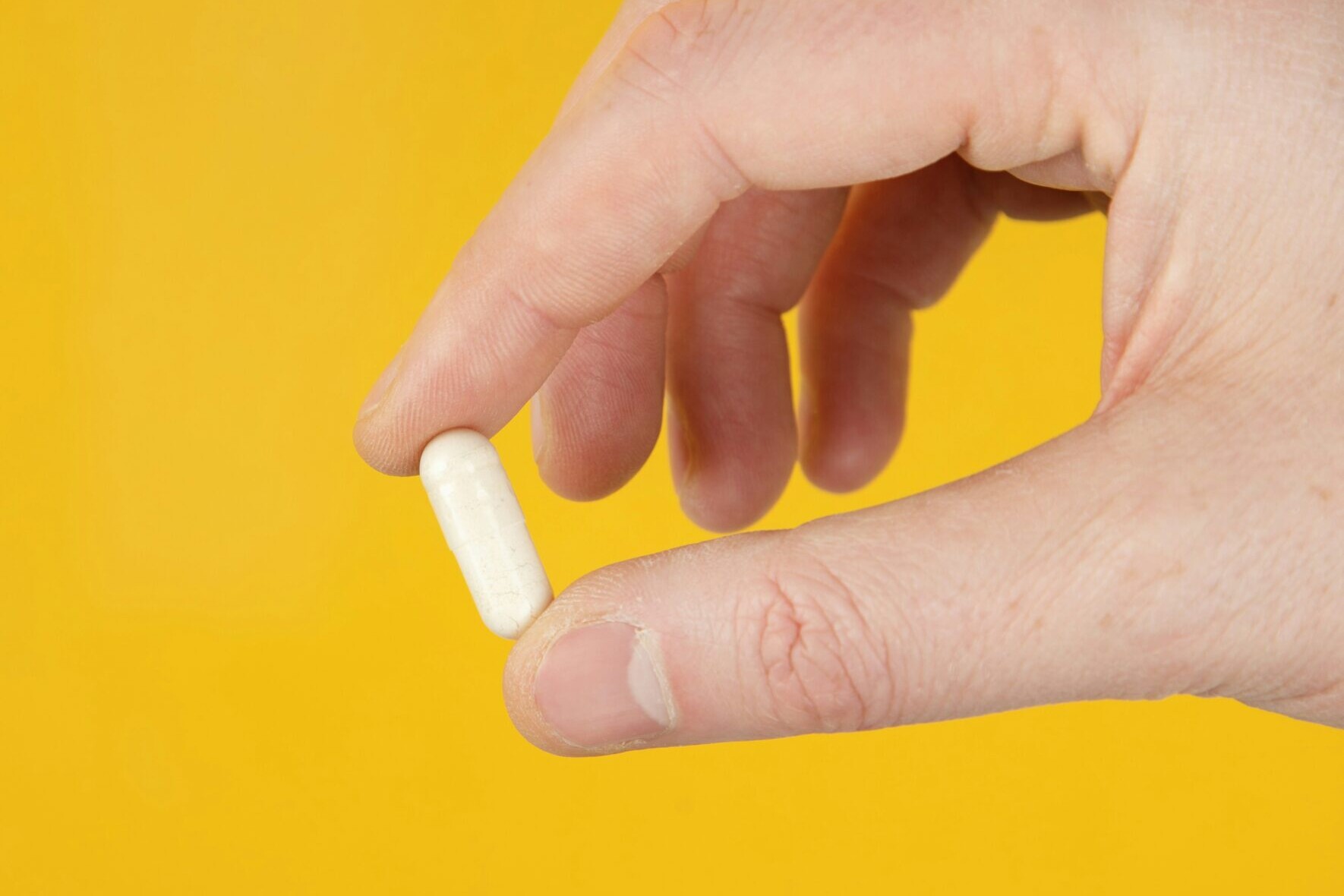 person holding white cigarette stick