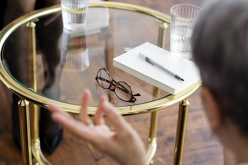 Woman in Black Shirt Sitting on Chair