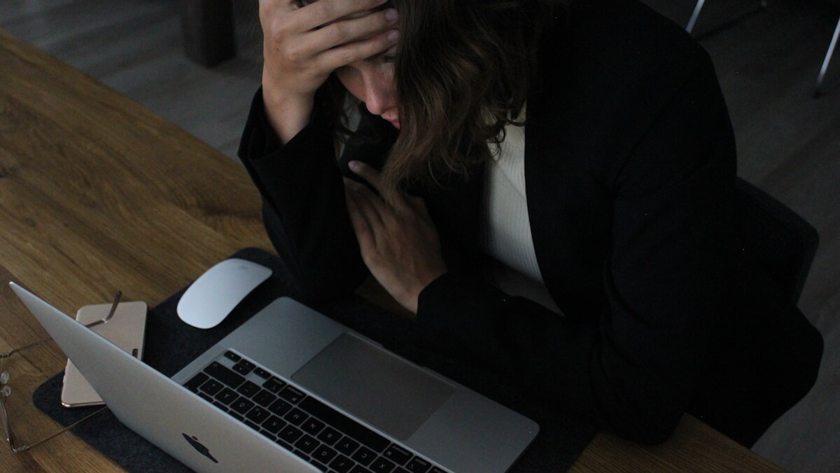 woman in black blazer sitting on chair