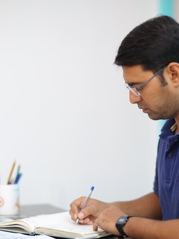 Man in Blue Polo Shirt Writing