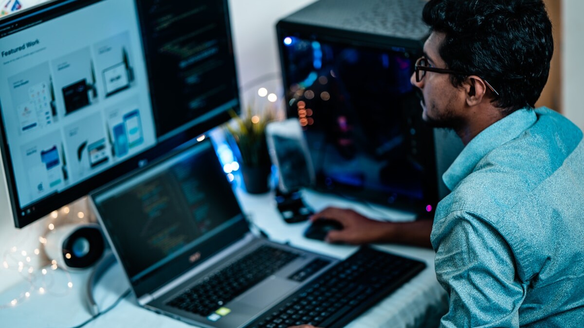 man in blue dress shirt using computer