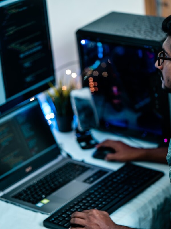 man in blue dress shirt using computer