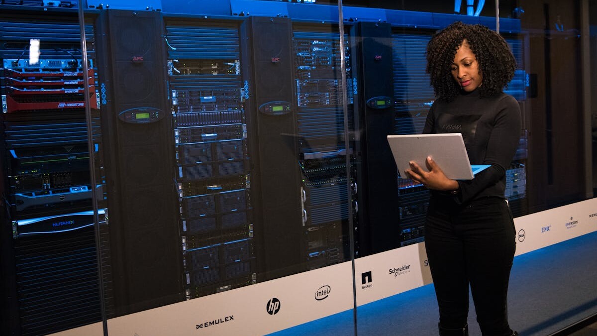 Software Engineer Standing Beside Server Racks