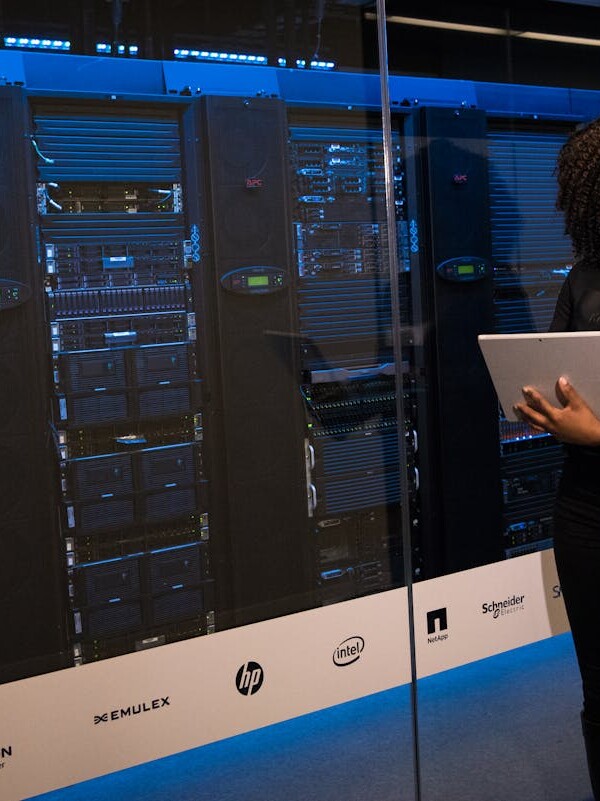 Software Engineer Standing Beside Server Racks