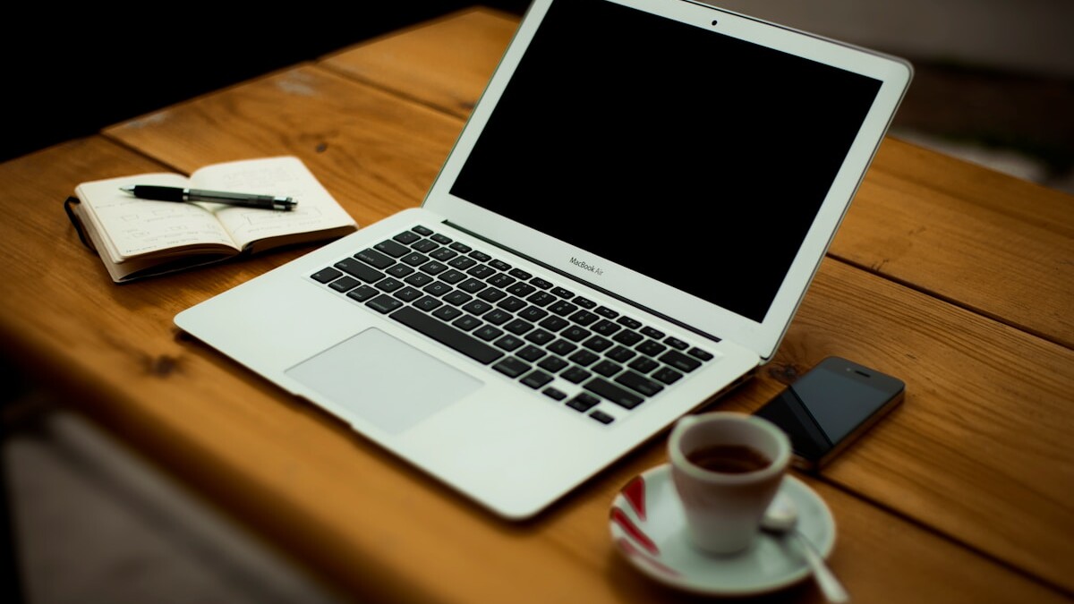 MacBook Air on brown wooden table