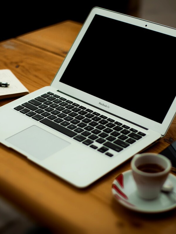 MacBook Air on brown wooden table