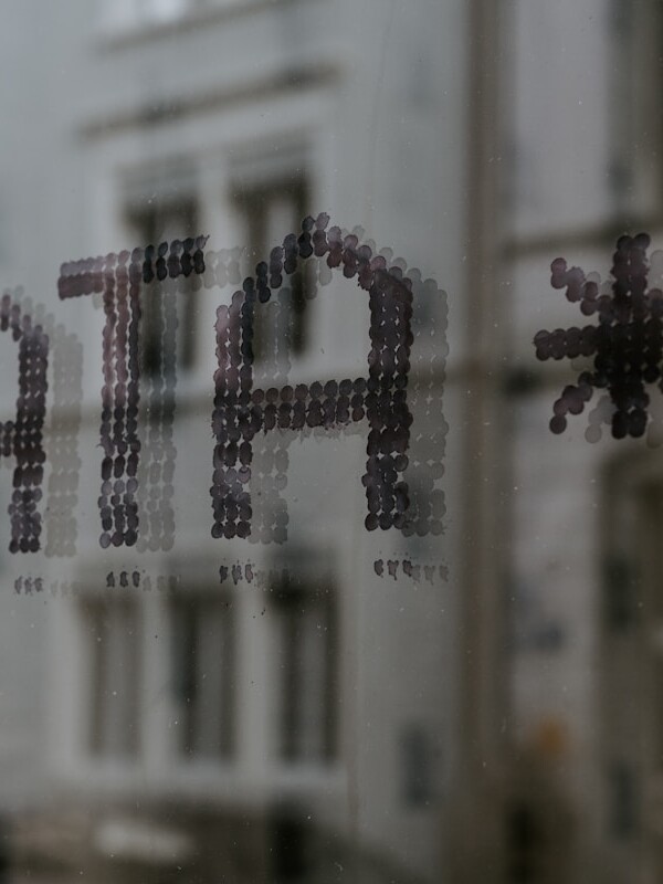 a close up of a window with a building in the background