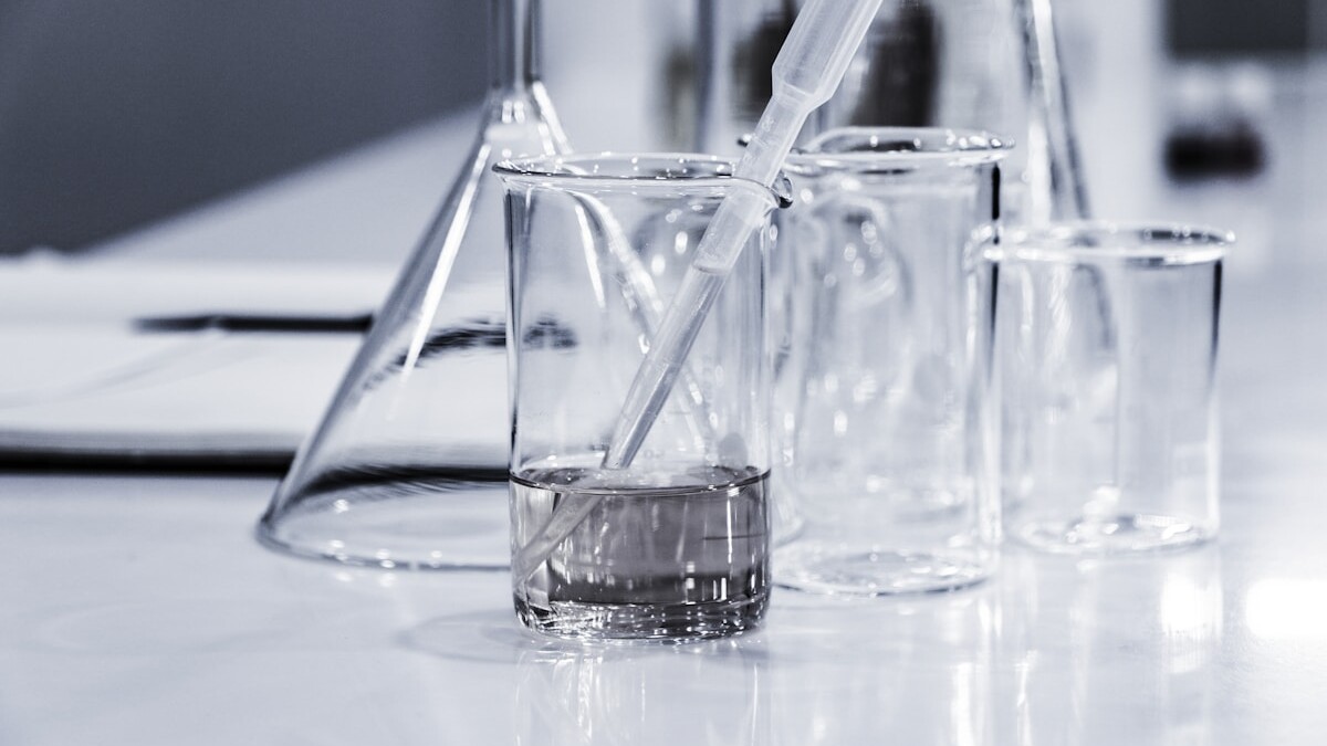 three clear beakers placed on tabletop