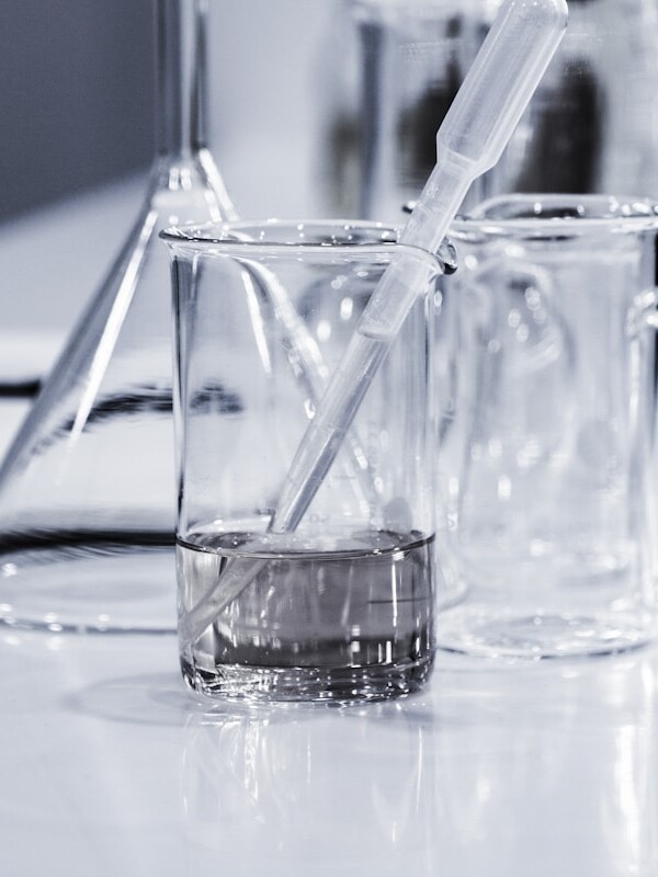 three clear beakers placed on tabletop