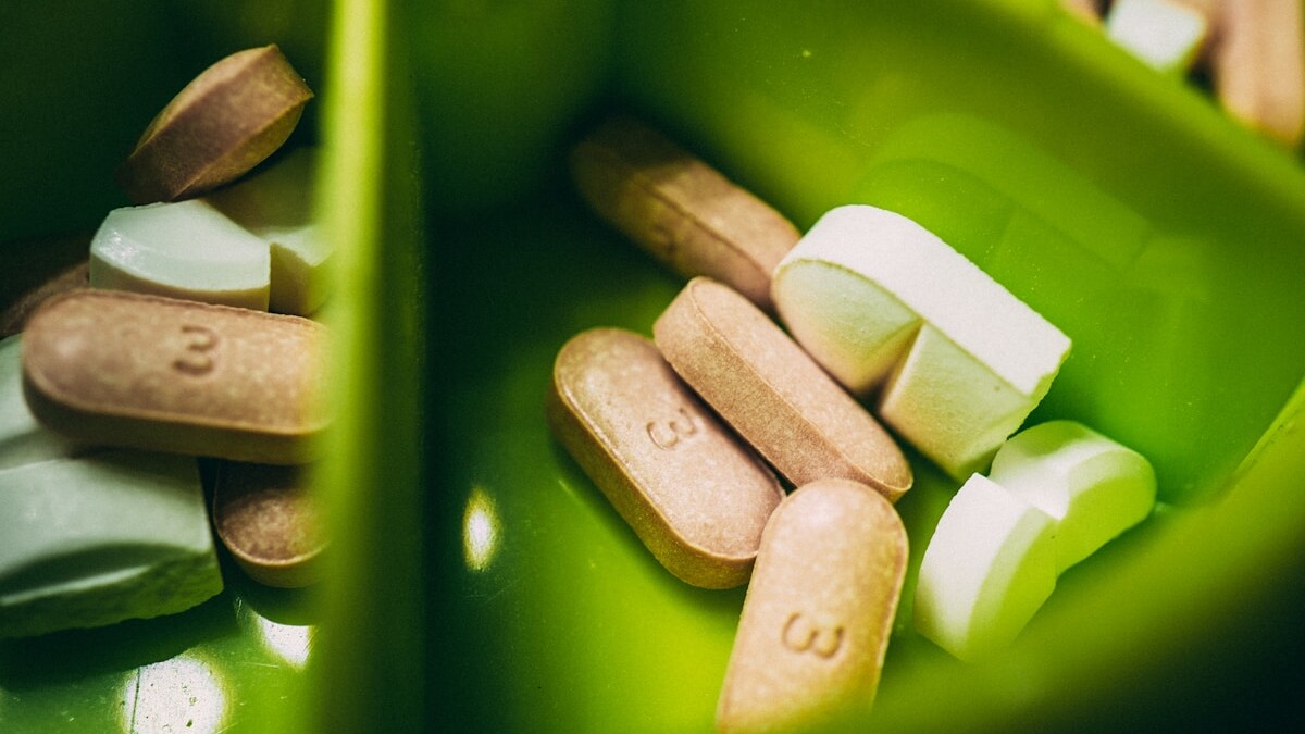 white medication pill on green plastic container