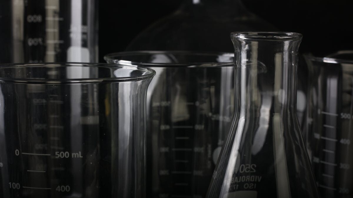 A detailed close-up of various transparent laboratory glassware used in scientific experiments.