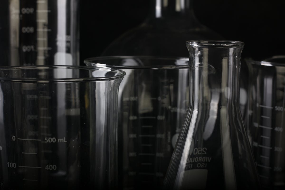 A detailed close-up of various transparent laboratory glassware used in scientific experiments.