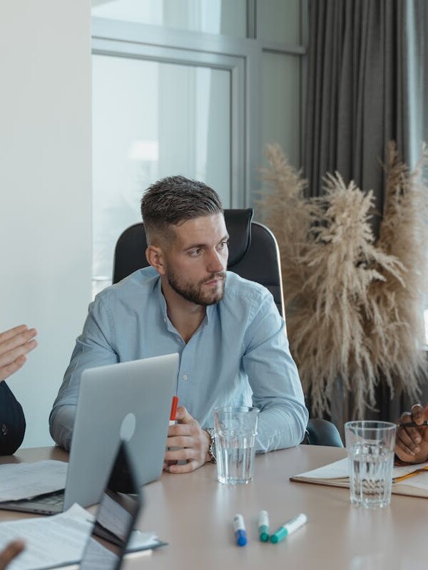 A group of professionals engaging in a collaborative discussion in a modern office setting.