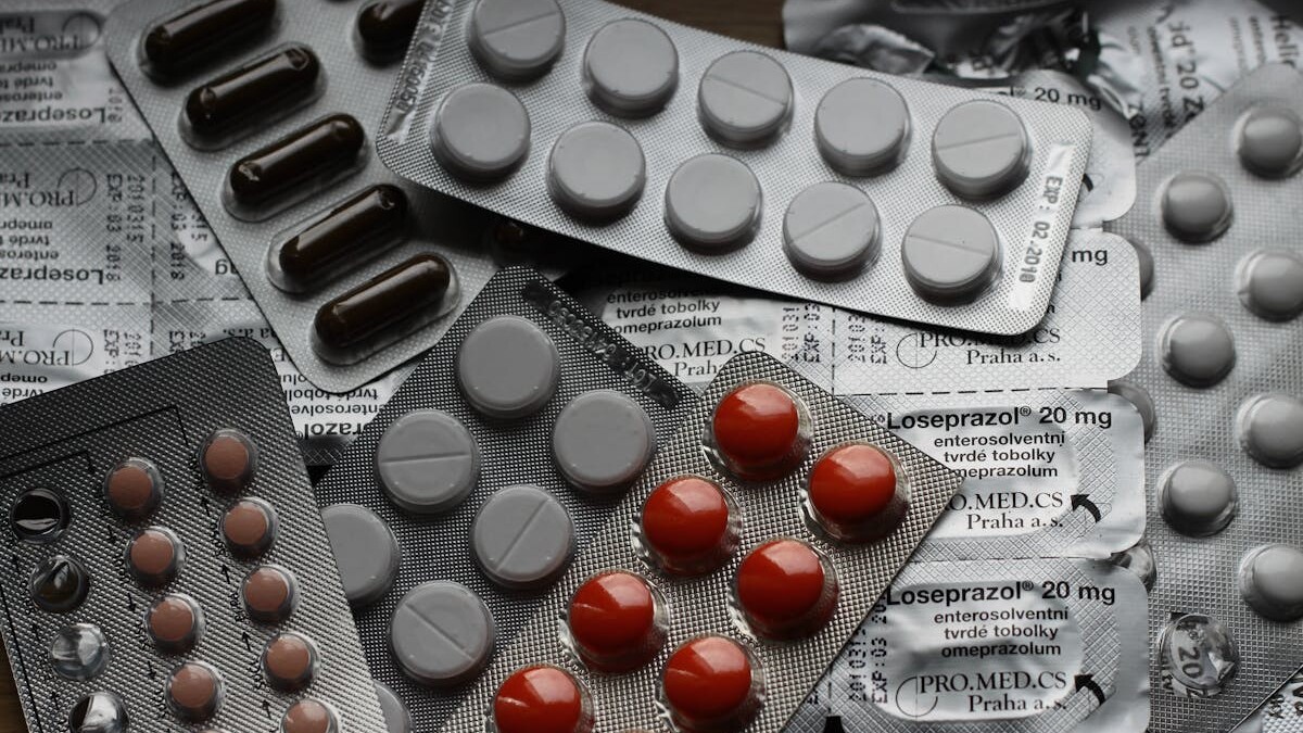 Close-up of various pills in blister packs showcasing medical and healthcare themes.