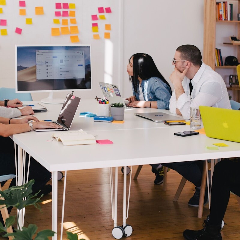 five person by table watching turned on white iMac